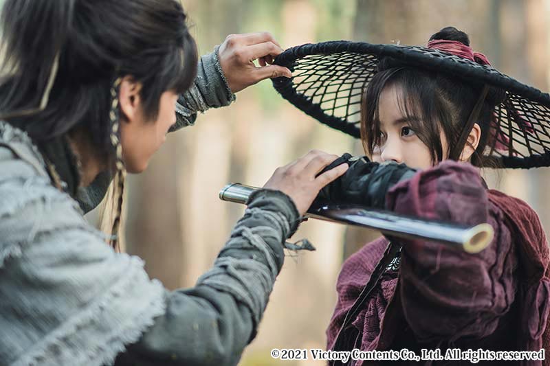 女性の腕をつかみ、顔を覗き込む男性